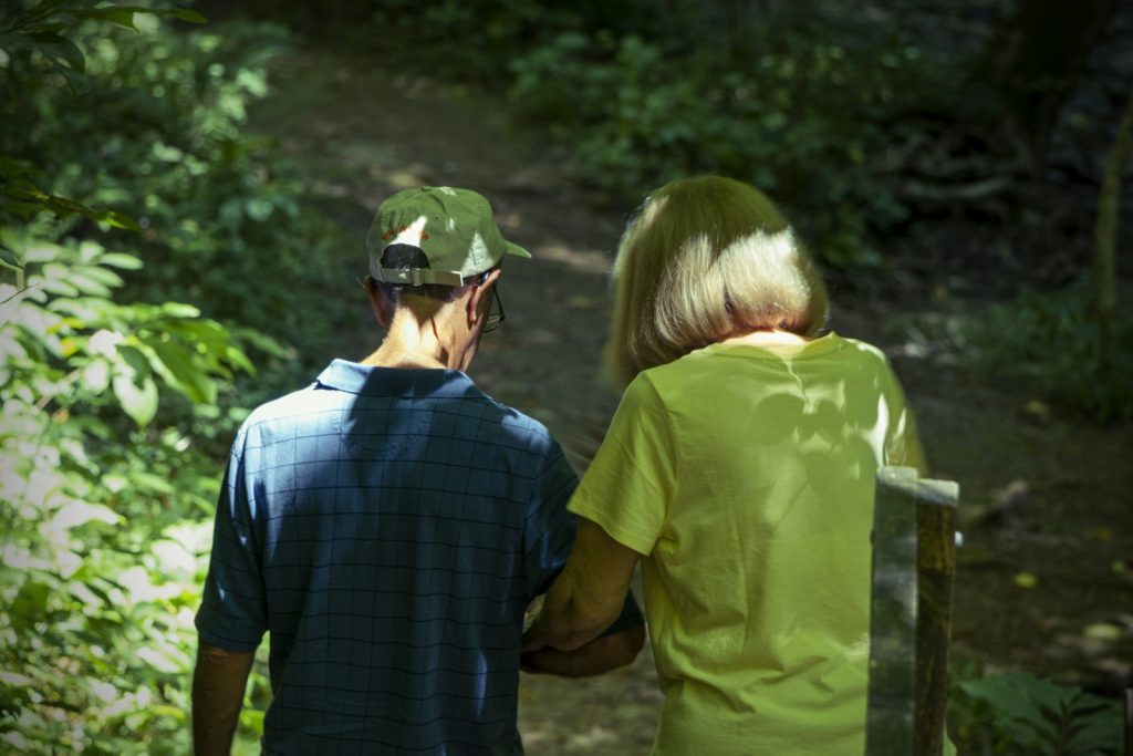 Companion walking outdoors with a senior woman as part of companion care in Edmonton