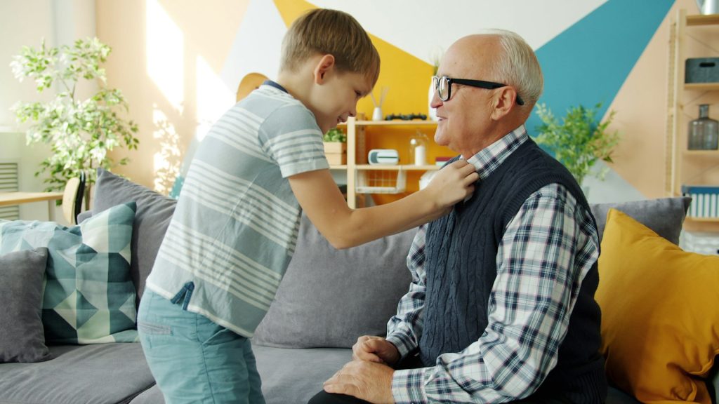 Caregiver helping a senior man at home during respite care in Edmonton